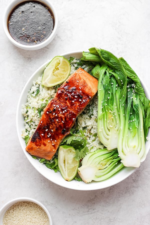 Easy Ginger Sesame Salmon (Asian-Inspired) - this recipe is packed with flavor, comes together so easily and family-friendly! Don't forget to make extra so you have some to take to work for lunch the next day!!! And the asian salmon glaze/marinade will become a favorite for sure!! #asiansalmon #healthyfishrecipes #whole30dinner #whole30recipes #paleorecipes #glutenfreerecipes An easy recipe for the best ginger sesame salmon.