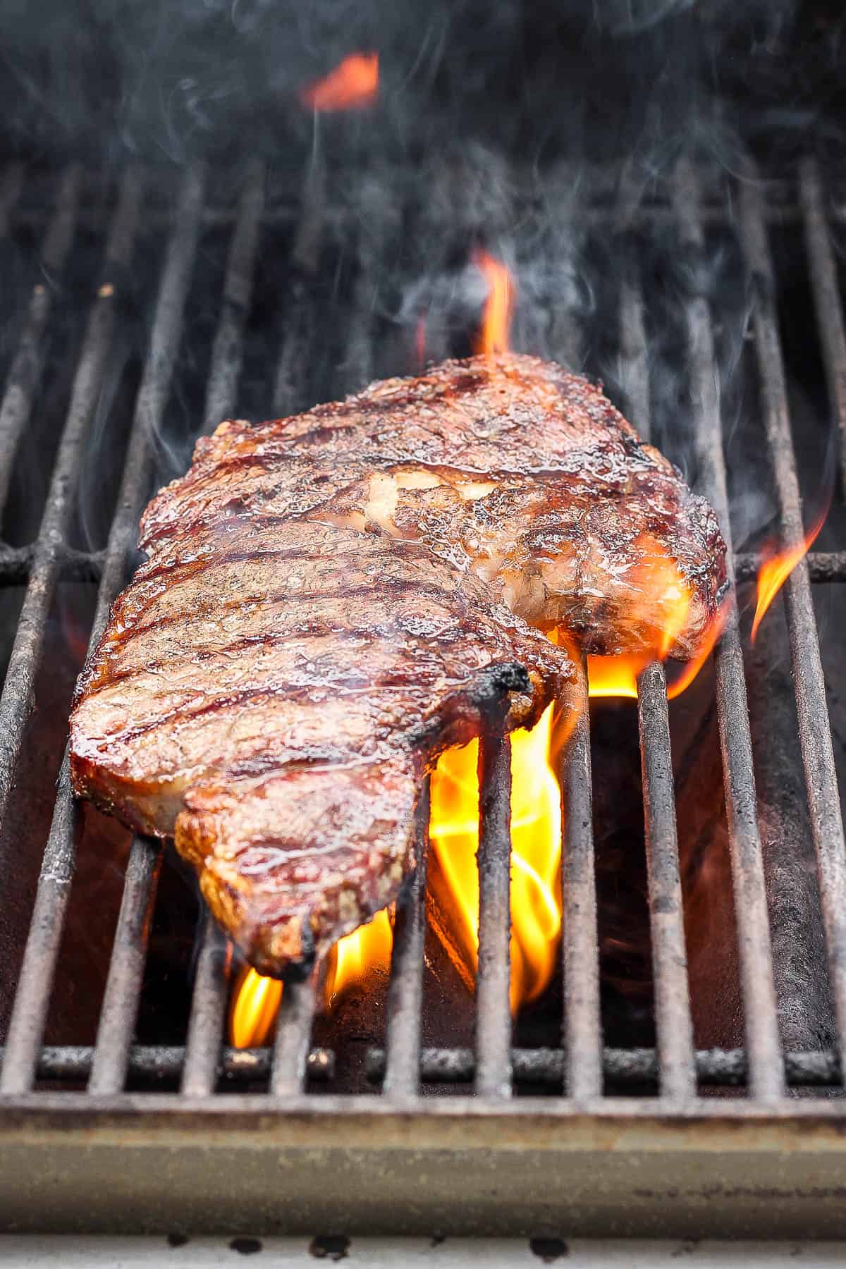 A ribeye steak on the grill.