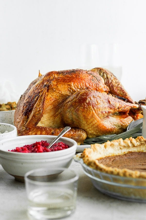 A whole grilled turkey on a platter.